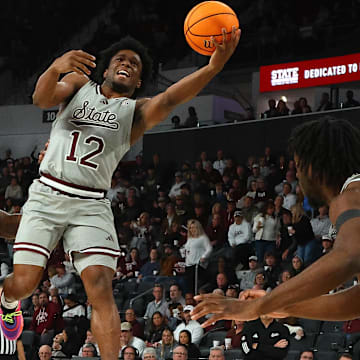 Feb 18, 2025; Starkville, Mississippi, USA; Mississippi State Bulldogs guard Josh Hubbard (12) shoots against Texas A&M Aggies guard Manny Obaseki (35) during the second half at Humphrey Coliseum. Mandatory Credit: Petre Thomas-Imagn Images