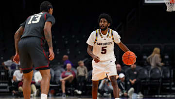 Dec 6, 2025; Phoenix, Arizona, USA; Arizona State University Sun Devils guard Moe Odum (5) dribbles down court against Oklahoma University Sooners forward Tae Davis (13) in the second half at PHX Arena. Mandatory Credit: Anna Carrington-Imagn Images