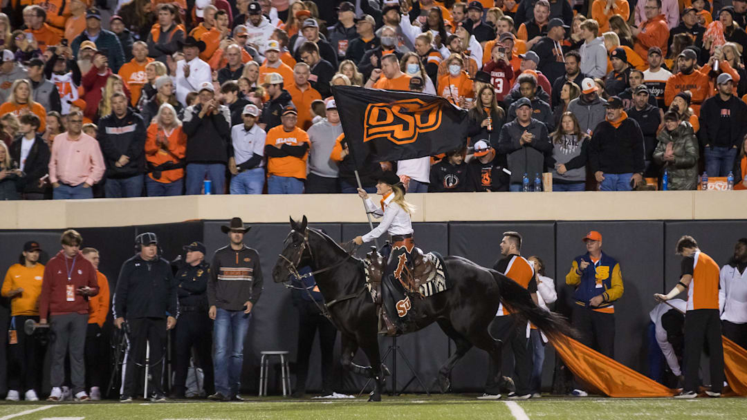Nov 27, 2021; Stillwater, Oklahoma, USA;  Oklahoma State Cowboys    Spirit Rider    rides    Bullet    after a Cowboys touchdown during the first quarter against the Oklahoma Sooners at Boone Pickens Stadium. Oklahoma State Cowboys won 37-33. Mandatory Credit: Brett Rojo-Imagn Images