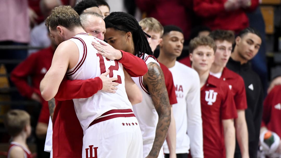 Mar 4, 2026; Bloomington, Indiana, USA; Indiana Hoosiers head coach Darian DeVries greets Indiana Hoosiers forward Tucker DeVries (12) as he checks out of the game against the Minnesota Golden Gophers during the second half at Simon Skjodt Assembly Hall. Mandatory Credit: Robert Goddin-Imagn Images