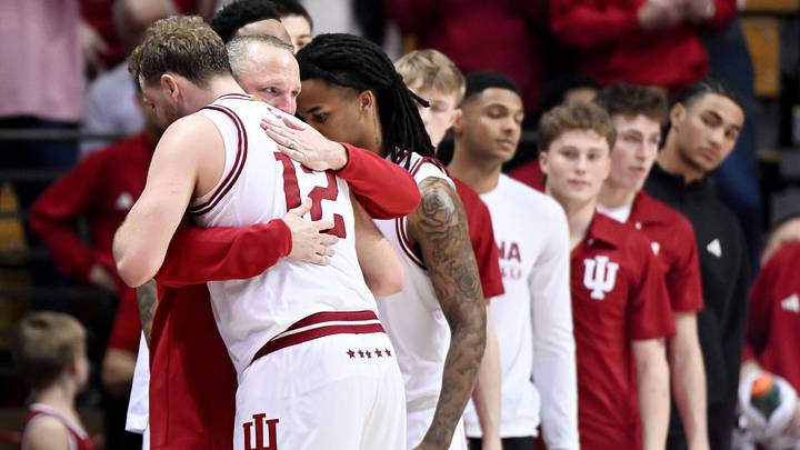 Mar 4, 2026; Bloomington, Indiana, USA; Indiana Hoosiers head coach Darian DeVries greets Indiana Hoosiers forward Tucker DeVries (12) as he checks out of the game against the Minnesota Golden Gophers during the second half at Simon Skjodt Assembly Hall. Mandatory Credit: Robert Goddin-Imagn Images