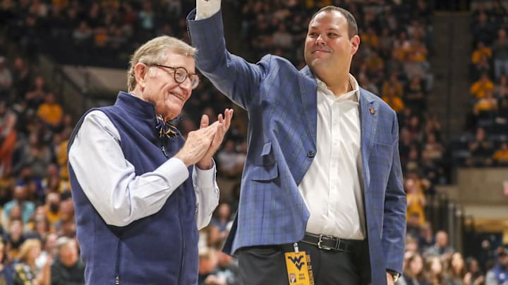 Dec 18, 2022; Morgantown, West Virginia, USA; West Virginia University President Gordon Gee welcomes new West Virginia Mountaineers Athletic Director Wren Baker during the first half against the Buffalo Bulls at WVU Coliseum. Mandatory Credit: Ben Queen-Imagn Images