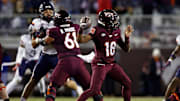 Nov 30, 2024; Blacksburg, Virginia, USA; Virginia Tech Hokies quarterback William Watson III (18) throws a pass during the second quarter against the Virginia Cavaliers at Lane Stadium. Mandatory Credit: Peter Casey-Imagn Images