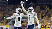 Nov 28, 2025; Tempe, Arizona, USA; Arizona Wildcats defensive back Treydan Stukes (2) celebrates with defensive back Ayden Garnes (9) after an interception against Arizona State Sun Devils in the second half during the 99th Territorial Cup at Mountain America Stadium. Mandatory Credit: Mark J. Rebilas-Imagn Images