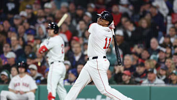 May 20, 2025; Boston, Massachusetts, USA; Boston Red Sox designated hitter Rafael Devers (11) hits a solo home run during the fifth inning against the New York Mets at Fenway Park. Mandatory Credit: Paul Rutherford-Imagn Images