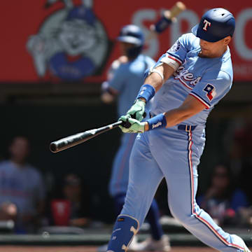 Sep 8, 2024; Arlington, Texas, USA; Texas Rangers first base Nathaniel Lowe (30) hits a two run home run against the Los Angeles Angels in the first inning at Globe Life Field. 