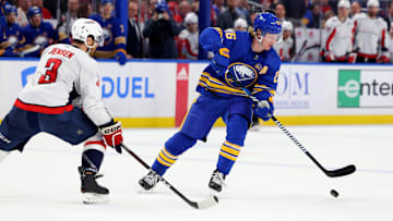 Apr 11, 2024; Buffalo, New York, USA;  Washington Capitals defenseman Nick Jensen (3) defends as Buffalo Sabres defenseman Rasmus Dahlin (26) looks to control the puck during the second period at KeyBank Center. Mandatory Credit: Timothy T. Ludwig-Imagn Images