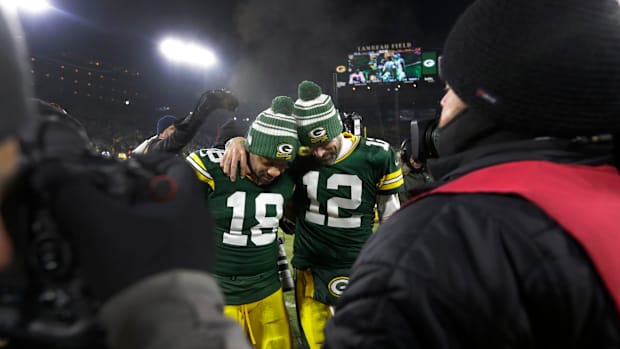 Green Bay Packers wide receiver Randall Cobb (18) and quarterback Aaron Rodgers (12) leave the field together.