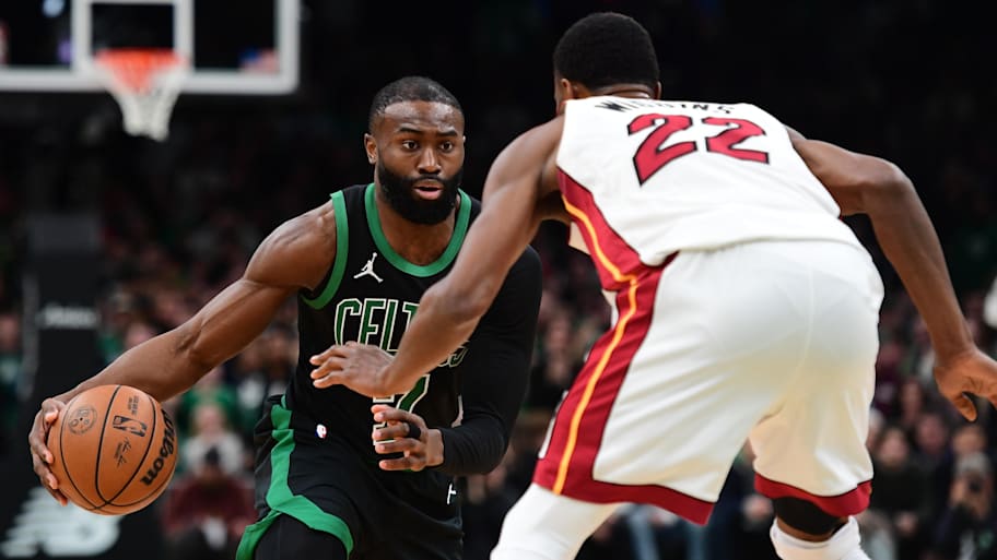 Boston Celtics guard Jaylen Brown dribbles against Miami Heat forward Andrew Wiggins.