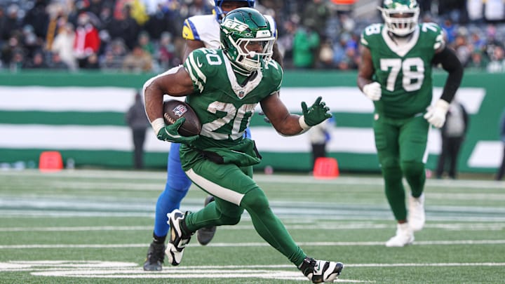 New York Jets running back Breece Hall carries the ball as Los Angeles Rams linebacker Byron Young pursues. New York Jets running back Breece Hall carries the ball as Los Angeles Rams linebacker Byron Young pursues.