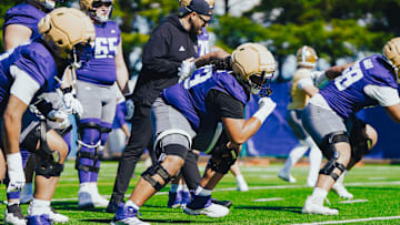 Champ Taulealea comes out of a stance during Husky spring ball. 