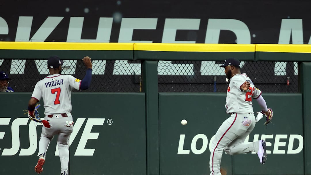 Jul 27, 2025; Arlington, Texas, USA; Atlanta Braves outfielder Jurickson Profar (7) and Atlanta Braves outfielder Michael Harris II (23) cannot catch a ball hit by Texas Rangers outfielder Wyatt Langford (not pictured) during the first inning at Globe Life Field. Mandatory Credit: Tim Heitman-Imagn Images