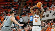 Jan 27, 2024; Stillwater, Oklahoma, USA; Oklahoma State Cowboys guard Javon Small (12) controls the ball against West Virginia Mountaineers guard Kerr Kriisa (3) during the first half at Gallagher-Iba Arena. Mandatory Credit: William Purnell-Imagn Images