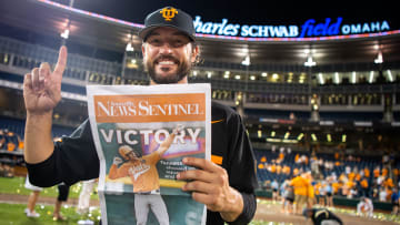 Tennessee head coach Tony Vitello holds up a commemorative News Sentinel front page after game three of the NCAA College World Series finals between Tennessee and Texas A&M at Charles Schwab Field in Omaha, Neb., on Monday, June 24, 2024.
