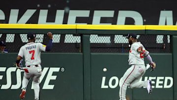 Jul 27, 2025; Arlington, Texas, USA; Atlanta Braves outfielder Jurickson Profar (7) and Atlanta Braves outfielder Michael Harris II (23) cannot catch a ball hit by Texas Rangers outfielder Wyatt Langford (not pictured) during the first inning at Globe Life Field. Mandatory Credit: Tim Heitman-Imagn Images