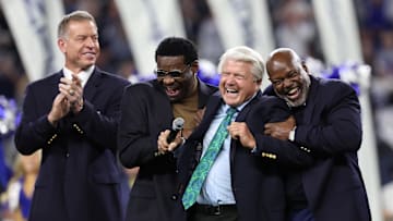 Dallas Cowboys former head coach Jimmy Johnson laughs with former players Troy Aikman, Michael Irvin, and Emmitt Smith after being inducted into the Ring of Honor. 