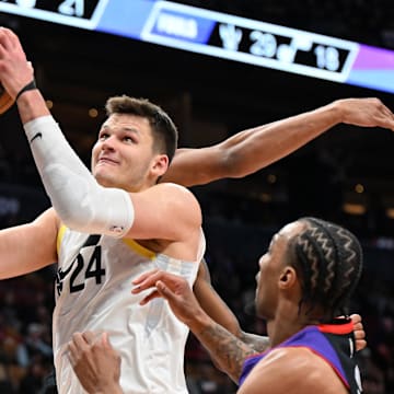 Mar 7, 2025; Toronto, Ontario, CAN;  Utah Jazz center Walker Kessler (24) goes in for a layup over Toronto Raptors guard AJ Lawson (0) in the second half at Scotiabank Arena. Mandatory Credit: Dan Hamilton-Imagn Images