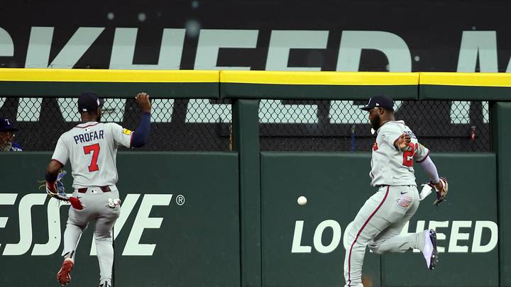 Jul 27, 2025; Arlington, Texas, USA; Atlanta Braves outfielder Jurickson Profar (7) and Atlanta Braves outfielder Michael Harris II (23) cannot catch a ball hit by Texas Rangers outfielder Wyatt Langford (not pictured) during the first inning at Globe Life Field. Mandatory Credit: Tim Heitman-Imagn Images