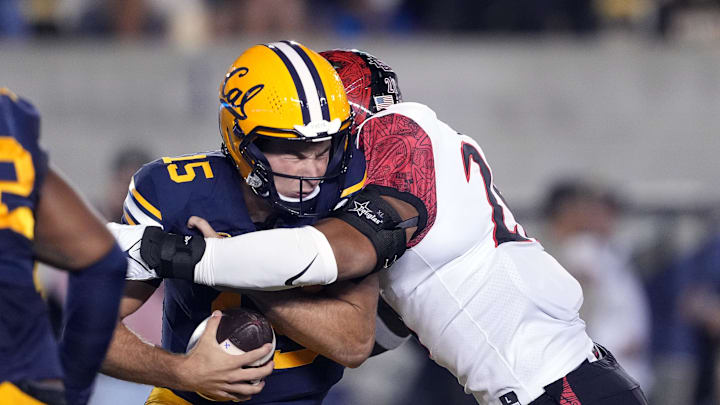 San Diego State linebacker Tano Letuli (right) sacks Cal quarterback Fernando Mendoza