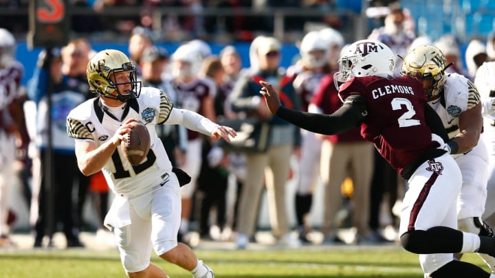 Dec 29, 2017; Charlotte, NC, USA; Wake Forest Demon Deacons quarterback John Wolford (10) drops back to pass while being pressured by Texas A&M Aggies defensive lineman Micheal Clemons (2) in the first quarter in the 2017 Belk Bowl at Bank of America Stadium.