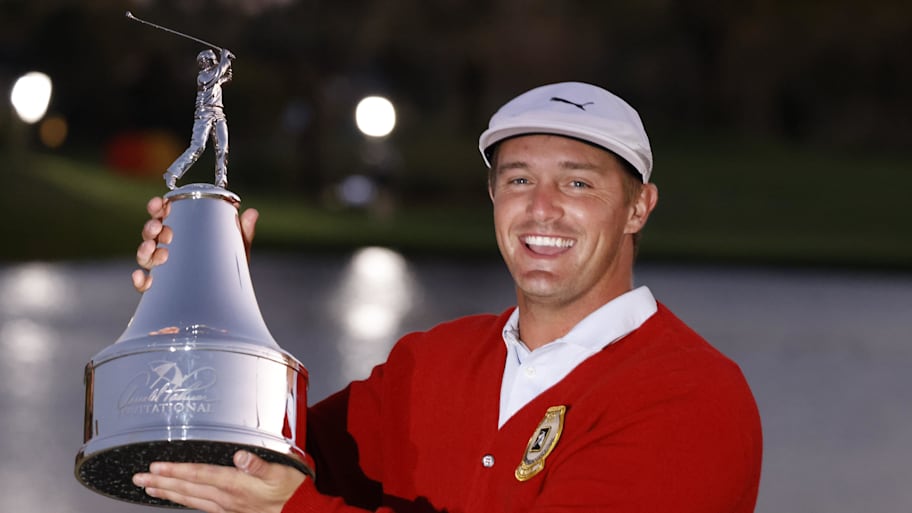 Bryson DeChambeau holds the champions trophy after winning the 2021 Arnold Palmer Invitational .