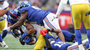 Dec 31, 2023; East Rutherford, New Jersey, USA; Los Angeles Rams running back Kyren Williams (23) is tackled by New York Giants linebacker Bobby Okereke (58) and defensive tackle Timmy Horne (96) during the second half at MetLife Stadium. Mandatory Credit: Vincent Carchietta-USA TODAY Sports
