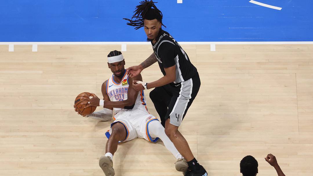 May 26, 2026; Oklahoma City, Oklahoma, USA; Oklahoma City Thunder guard Shai Gilgeous-Alexander (2) and San Antonio Spurs guard Stephon Castle (5) look at referee Sean Wright (4) after a call during the second quarter in game five of the western conference finals for the 2026 NBA playoffs at Paycom Center. Mandatory Credit: Brett Rojo-Imagn Images