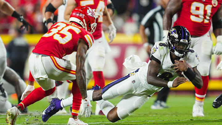 Sep 5, 2024; Kansas City, Missouri, USA; Baltimore Ravens quarterback Lamar Jackson (8) dives forward against Kansas City Chiefs cornerback Jaylen Watson (35) during the first half at GEHA Field at Arrowhead Stadium. Mandatory Credit: Jay Biggerstaff-Imagn Images