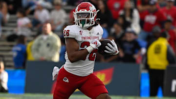 Nov 30, 2024; Pasadena, California, USA; Fresno State Bulldogs running back Bryson Donelson (26) carries the ball during the third quarter against the UCLA Bruins at Rose Bowl. Mandatory Credit: Robert Hanashiro-Imagn Images