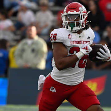 Nov 30, 2024; Pasadena, California, USA; Fresno State Bulldogs running back Bryson Donelson (26) carries the ball during the third quarter against the UCLA Bruins at Rose Bowl. Mandatory Credit: Robert Hanashiro-Imagn Images