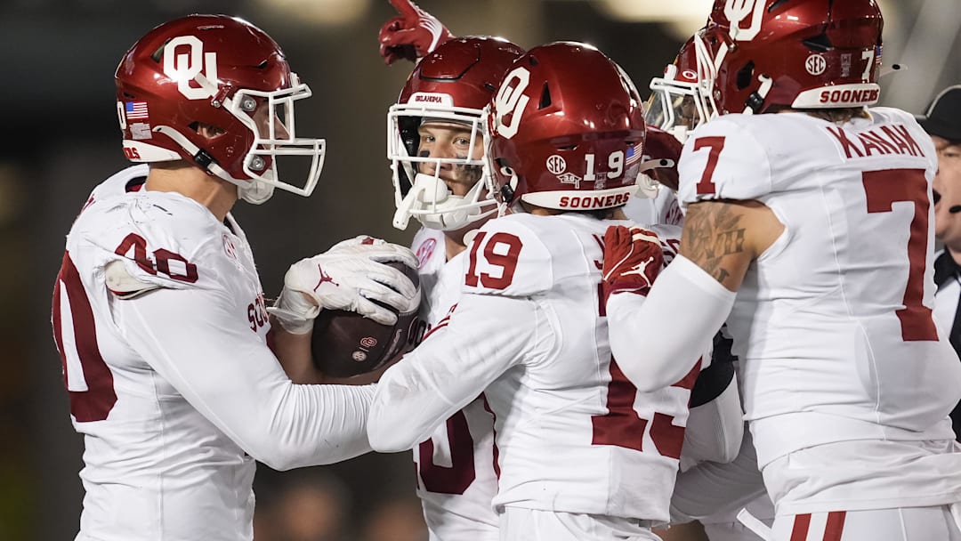 Nov 9, 2024; Columbia, Missouri, USA; Oklahoma Sooners tight end Bauer Sharp (10) is congratulated by teammates after a successful fake punt in the first half against the Missouri Tigers at Faurot Field at Memorial Stadium. Mandatory Credit: Jay Biggerstaff-Imagn Images