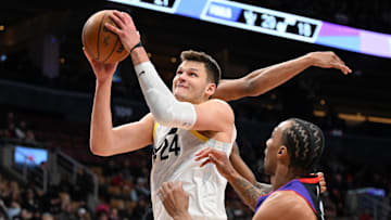 Mar 7, 2025; Toronto, Ontario, CAN;  Utah Jazz center Walker Kessler (24) goes in for a layup over Toronto Raptors guard AJ Lawson (0) in the second half at Scotiabank Arena. Mandatory Credit: Dan Hamilton-Imagn Images