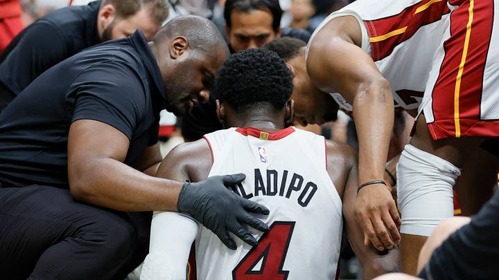 Apr 22, 2023; Miami, Florida, USA; Miami Heat guard Victor Oladipo (4) is checked on after an injury in the fourth quarter against the Milwaukee Bucks during game three of the 2023 NBA Playoffs at Kaseya Center. Mandatory Credit: Sam Navarro-USA TODAY Sports