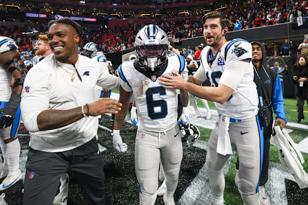 Carolina Panthers running back Miles Sanders (6) celebrates with teammates after a game-winning touchdown in overtime against