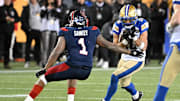 Nov 19, 2023; Hamilton, Ontario, CAN;  Winnipeg Blue Bombers wide receiver Nic Demski (10) tries to elude a tackle from Montreal Alouettes defensive back Darnell Sankey (1) in the second half at Tim Hortons Field. Mandatory Credit: Dan Hamilton-Imagn Images