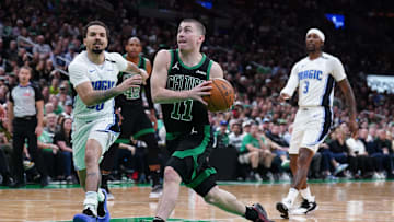 Apr 29, 2025; Boston, Massachusetts, USA; Boston Celtics guard Payton Pritchard (11) drives the ball against Orlando Magic guard Cole Anthony (50) in the third quarter during game five of first round for the 2025 NBA Playoffs at TD Garden. Mandatory Credit: David Butler II-Imagn Images
