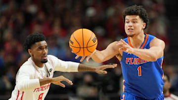 Apr 7, 2025; San Antonio, TX, USA; Florida Gators guard Walter Clayton Jr. (1) passes the ball against Houston Cougars guard Mylik Wilson (8) during the first half of the national championship game of the Final Four of the 2025 NCAA Tournament at the Alamodome. Mandatory Credit: Bob Donnan-Imagn Images