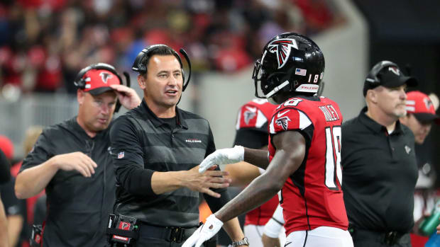 Sep 23, 2018; Atlanta, GA, USA; Atlanta Falcons offensive coordinator Steve Sarkisian greets wide receiver Calvin Ridley (18)