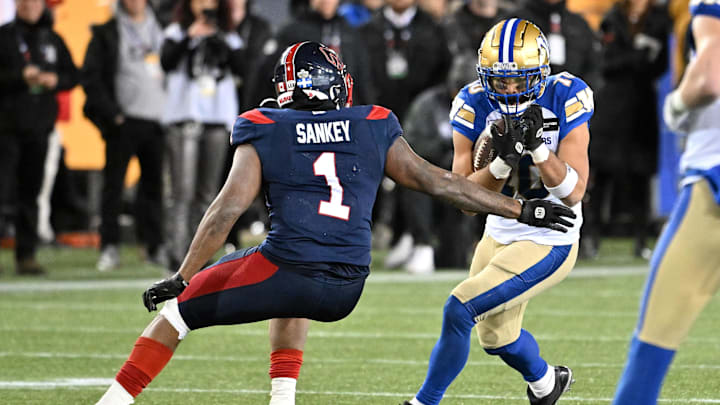 Nov 19, 2023; Hamilton, Ontario, CAN; Winnipeg Blue Bombers wide receiver Nic Demski (10) tries to elude a tackle from Montreal Alouettes defensive back Darnell Sankey (1) in the second half at Tim Hortons Field. Mandatory Credit: Dan Hamilton-Imagn Images Nov 19, 2023; Hamilton, Ontario, CAN; Winnipeg Blue Bombers wide receiver Nic Demski (10) tries to elude a tackle from Montreal Alouettes defensive back Darnell Sankey (1) in the second half at Tim Hortons Field. Mandatory Credit: Dan Hamilton-Imagn Images