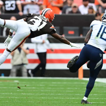 Sep 24, 2023; Cleveland, Ohio, USA; Cleveland Browns cornerback Denzel Ward (21) leaps to defend a pass to Tennessee Titans wide receiver Treylon Burks (16) during the second half at Cleveland Browns Stadium. Mandatory Credit: Ken Blaze-USA TODAY Sports