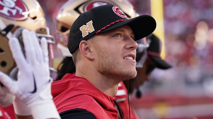 San Francisco 49ers running back Christian McCaffrey stands on the sidelines during a game.