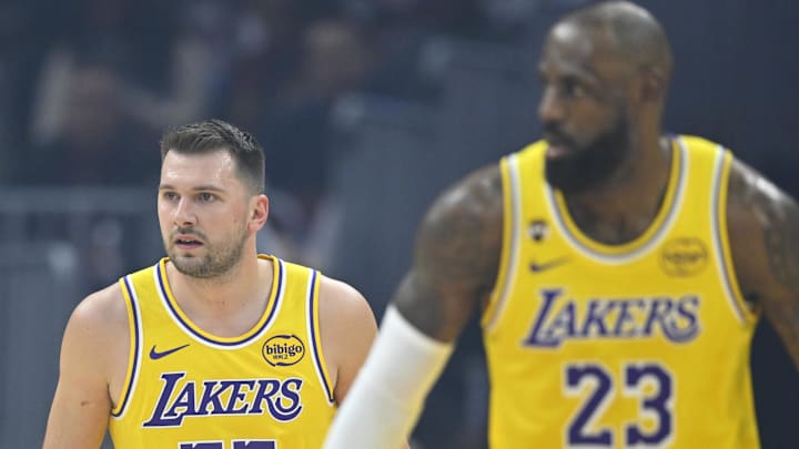Jan 28, 2026; Cleveland, Ohio, USA; Los Angeles Lakers guard Luka Doncic (77) and forward LeBron James (23) stand on the court in the first quarter against the Cleveland Cavaliers at Rocket Arena. Mandatory Credit: David Richard-Imagn Images