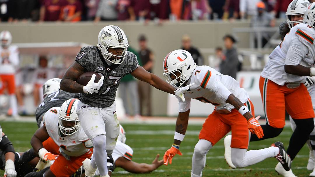 Nov 22, 2025; Blacksburg, Virginia, USA; Miami (FL) Hurricanes safety Zechariah Poyser (7) attempts to tackle Virginia Tech Hokies running back Marcellous Hawkins (27) during the first quarter at Lane Stadium. Mandatory Credit: Brian Bishop-Imagn Images