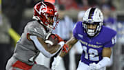 Nov 5, 2022; Louisville, Kentucky, USA;  Louisville Cardinals running back Jawhar Jordan (25) runs the ball against James Madison Dukes safety Josh Sarratt (12) during the second half at Cardinal Stadium. Louisville defeated James Madison 34-10. Mandatory Credit: Jamie Rhodes-Imagn Images