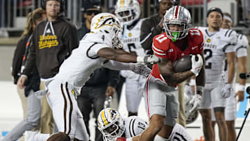 Sep 7, 2024; Columbus, Ohio, USA; Ohio State Buckeyes wide receiver Brandon Inniss (11) runs past Western Michigan Broncos linebacker Damari Roberson (4) after making a catch during the second half of the NCAA football game at Ohio Stadium.