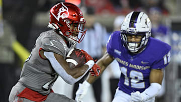 Nov 5, 2022; Louisville, Kentucky, USA;  Louisville Cardinals running back Jawhar Jordan (25) runs the ball against James Madison Dukes safety Josh Sarratt (12) during the second half at Cardinal Stadium. Louisville defeated James Madison 34-10. Mandatory Credit: Jamie Rhodes-Imagn Images