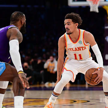 Jan 7, 2022; Los Angeles, California, USA; Atlanta Hawks guard Trae Young (11) controls the ball against Los Angeles Lakers forward LeBron James (6) during the first half at Crypto.com Arena. Mandatory Credit: Gary A. Vasquez-Imagn Images