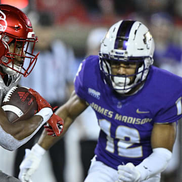 Nov 5, 2022; Louisville, Kentucky, USA;  Louisville Cardinals running back Jawhar Jordan (25) runs the ball against James Madison Dukes safety Josh Sarratt (12) during the second half at Cardinal Stadium. Louisville defeated James Madison 34-10. Mandatory Credit: Jamie Rhodes-Imagn Images