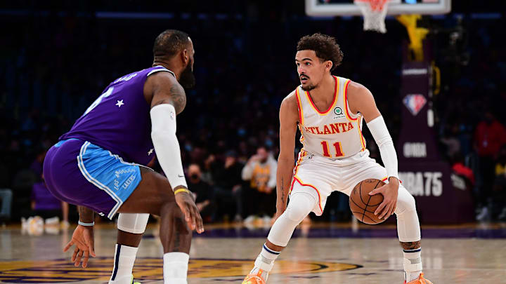 Jan 7, 2022; Los Angeles, California, USA; Atlanta Hawks guard Trae Young (11) controls the ball against Los Angeles Lakers forward LeBron James (6) during the first half at Crypto.com Arena. Mandatory Credit: Gary A. Vasquez-Imagn Images