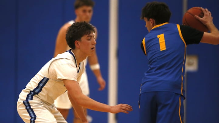 CovCath senior guard Athens McGillis (1) keeps an eye on NCC's Jack Stevie (1) as Covington Catholic defeated Newport Central Catholic 78-35 in boys basketball Jan. 3, 2026 at CovCath.
